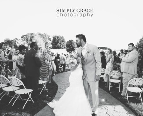 The Rhapsody Wedding kiss photo by Simply Grace Photography