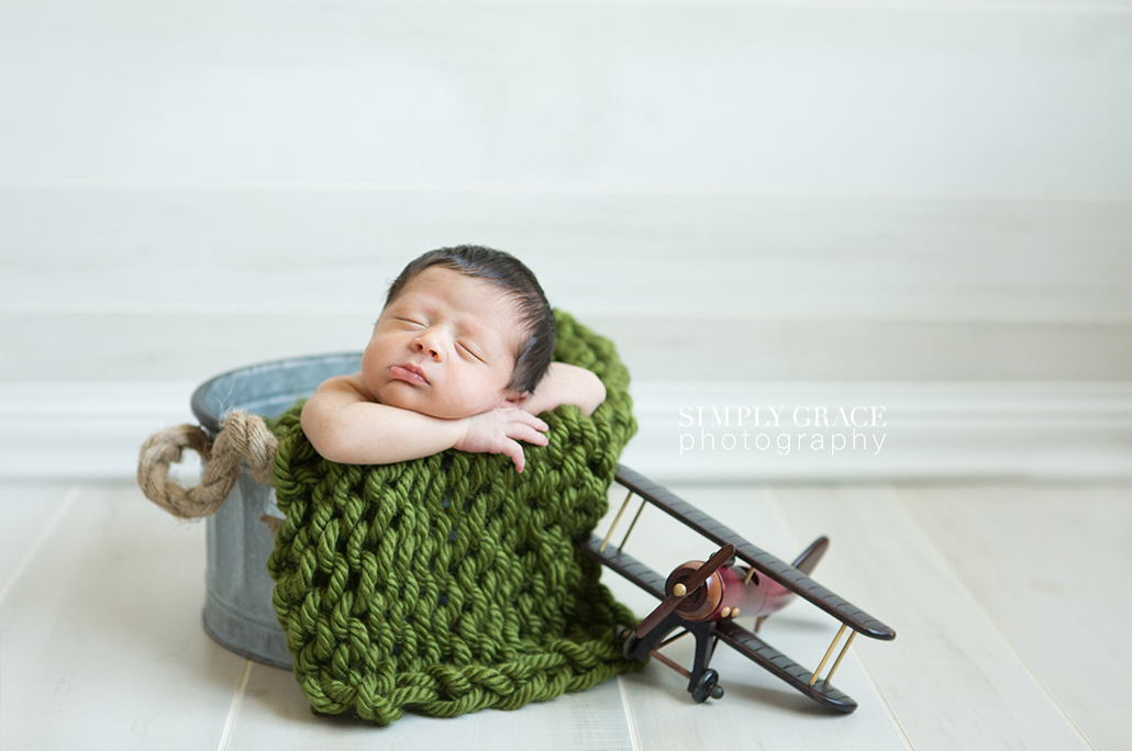 newborn with wood airplane savannah simply grace photography