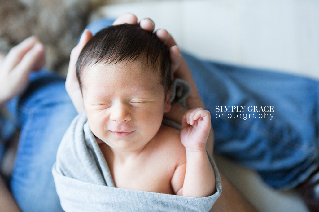 newborn smiling in dads arms savannah simply grace photography