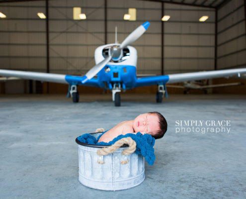 newborn in airplane hanger savannah simply grace photography
