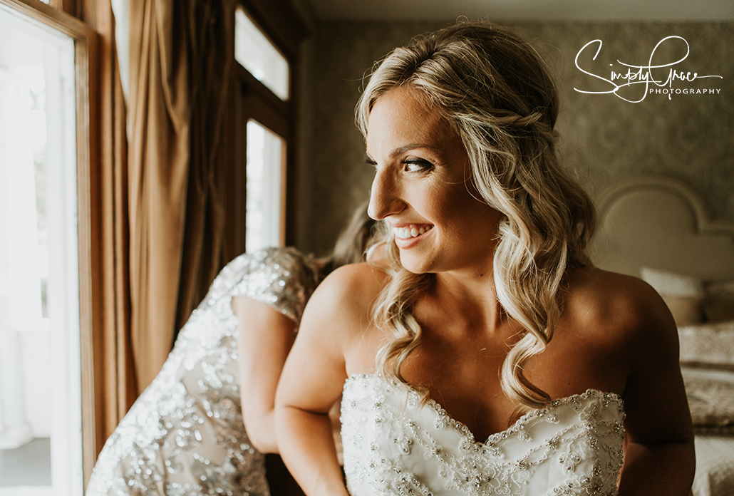 eighteen ninety wedding bride getting ready by window simply grace photography