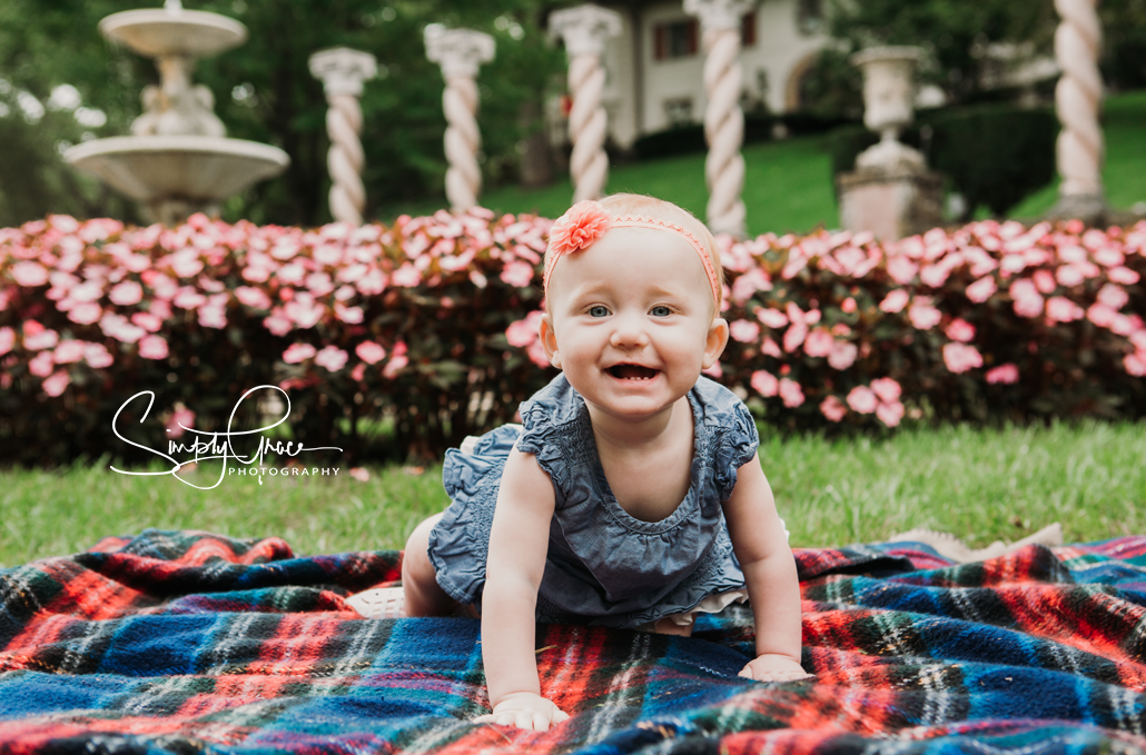 smiling 12 month old girl during family photo session at verona clumns