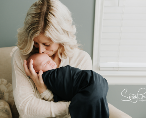 mom alone snuggling with baby in a newborn session simply grace photography