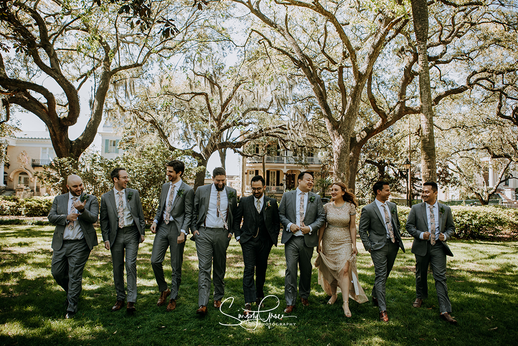 walking groomsmen photo at forsyth park savannah ga