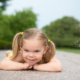 girl laying down smiling at the camera at nelson atkins museum