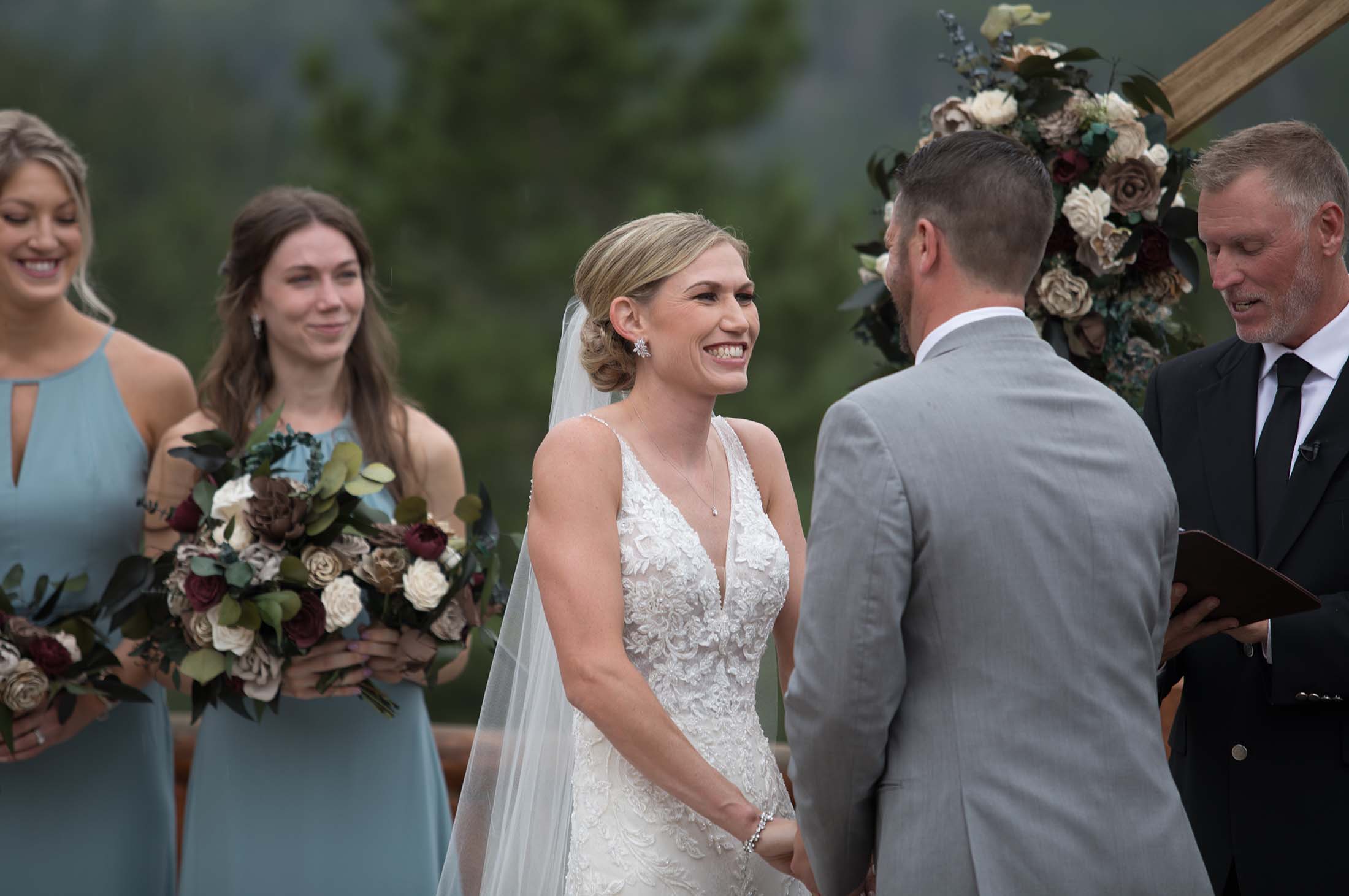 bride smiling at groom at the overlook chapel in estes park
