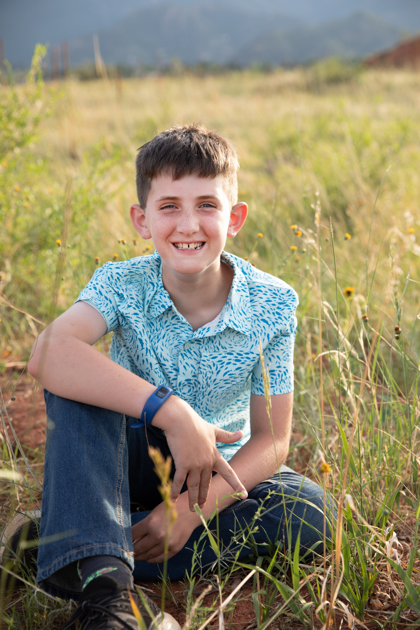 boy in blue shirt in photo session at red rocks open space