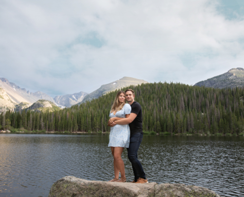 couple posing on rock at bear lake rocky mountain national park