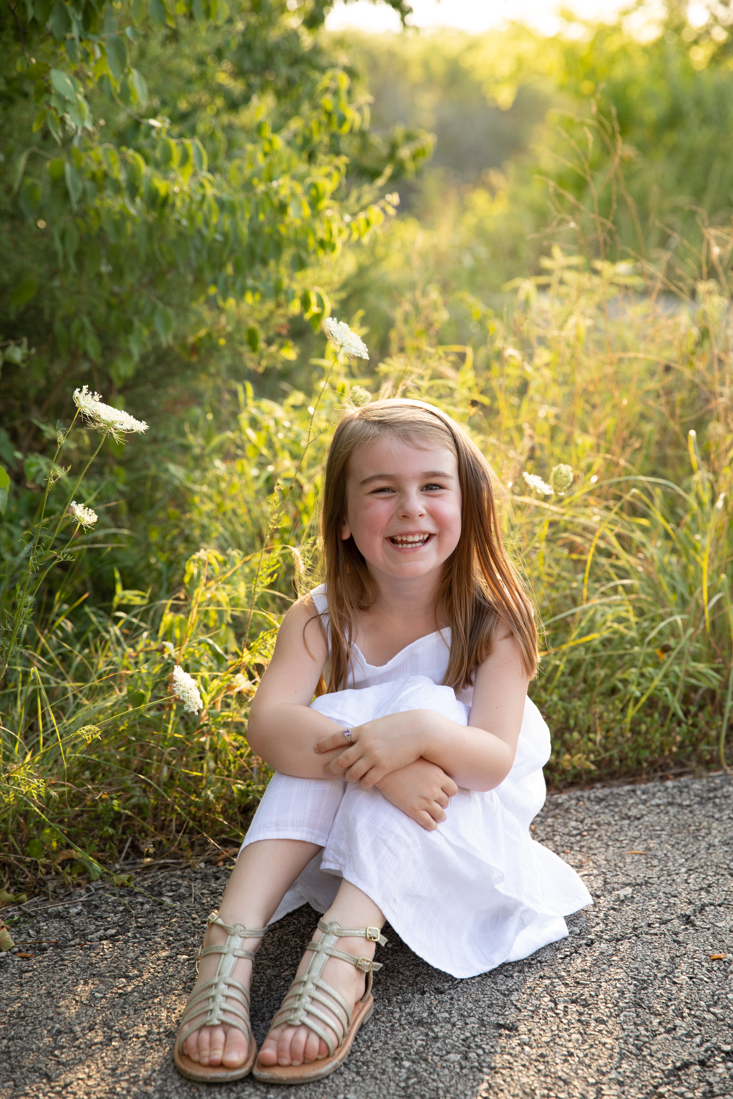 girl in white dress at sunset during a photo session in lees summit