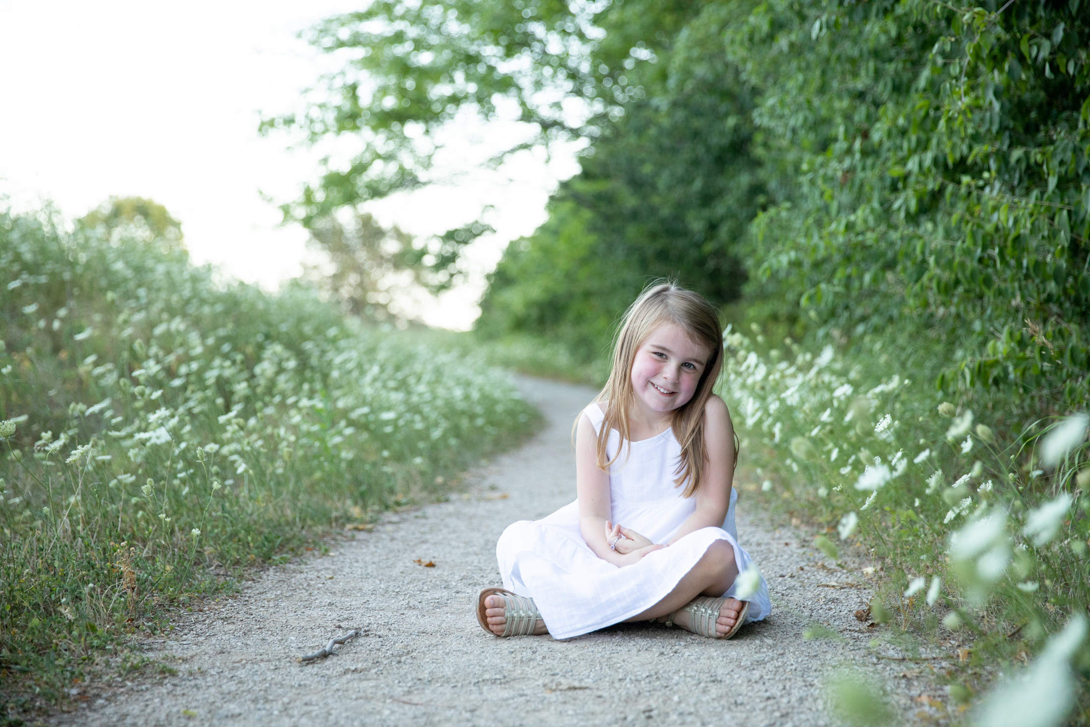 girl in white dresses among white flowers