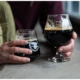 couple holding glasses of stout at red leg brewery