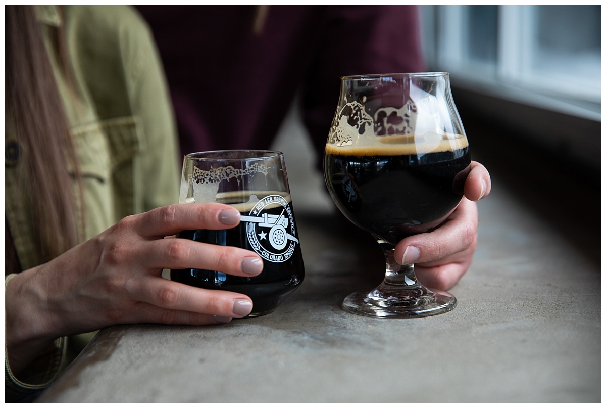 couple holding glasses of stout at red leg brewery