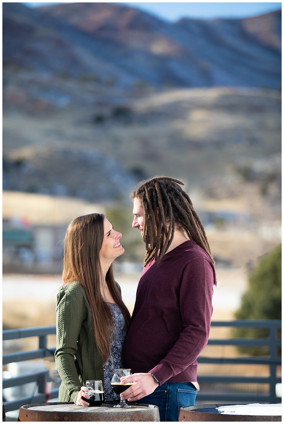 couple on the deck of red leg brewery doing an engagement session