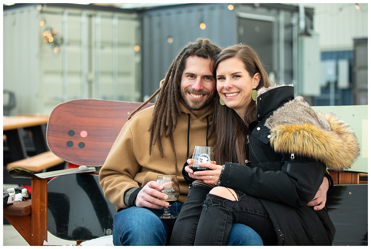 couple doing engagement session outside red leg brewery