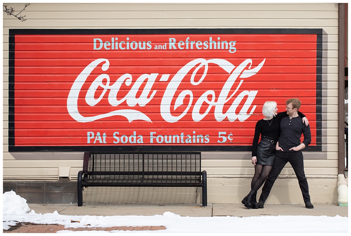 engagement session in downtown louisville colorado coca cola sign