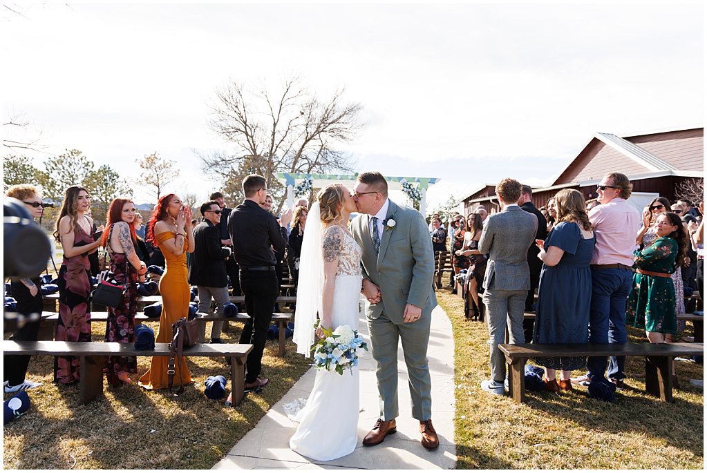 ceremony kiss at the barn of raccoon creek simply grace photography